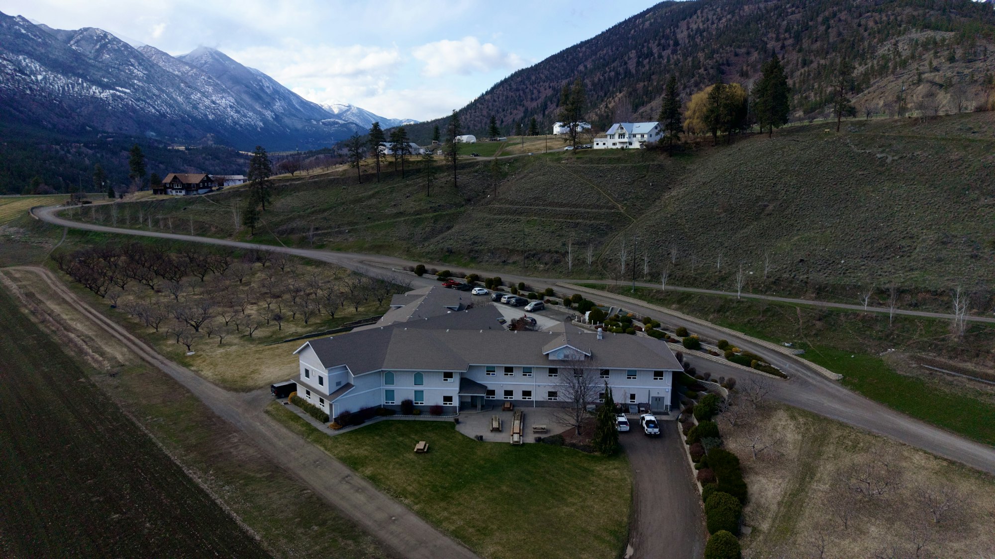 A two-story senior care facility with a covered entrance and landscaped grounds.