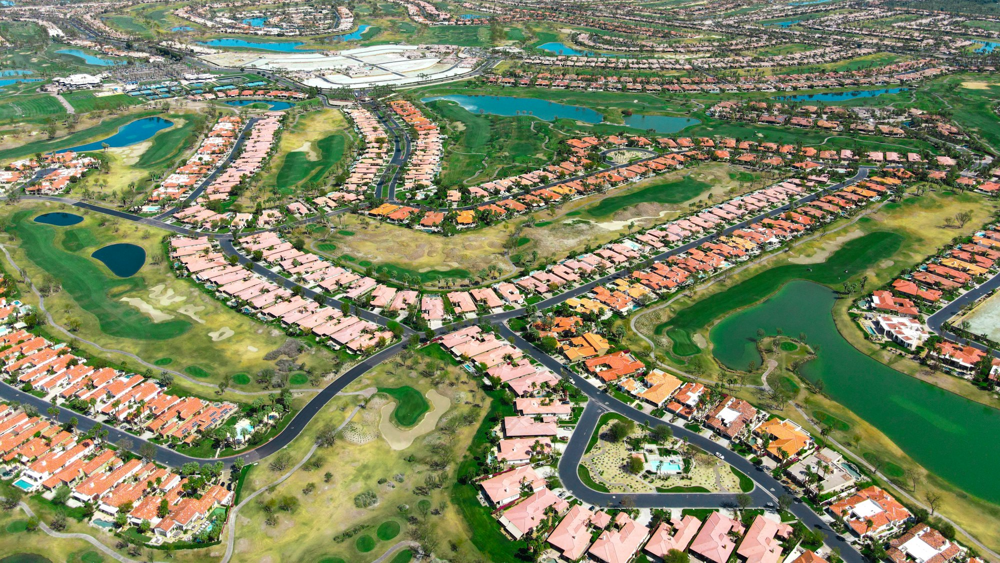 Aerial view of a low-density senior living community laid out around open green space.